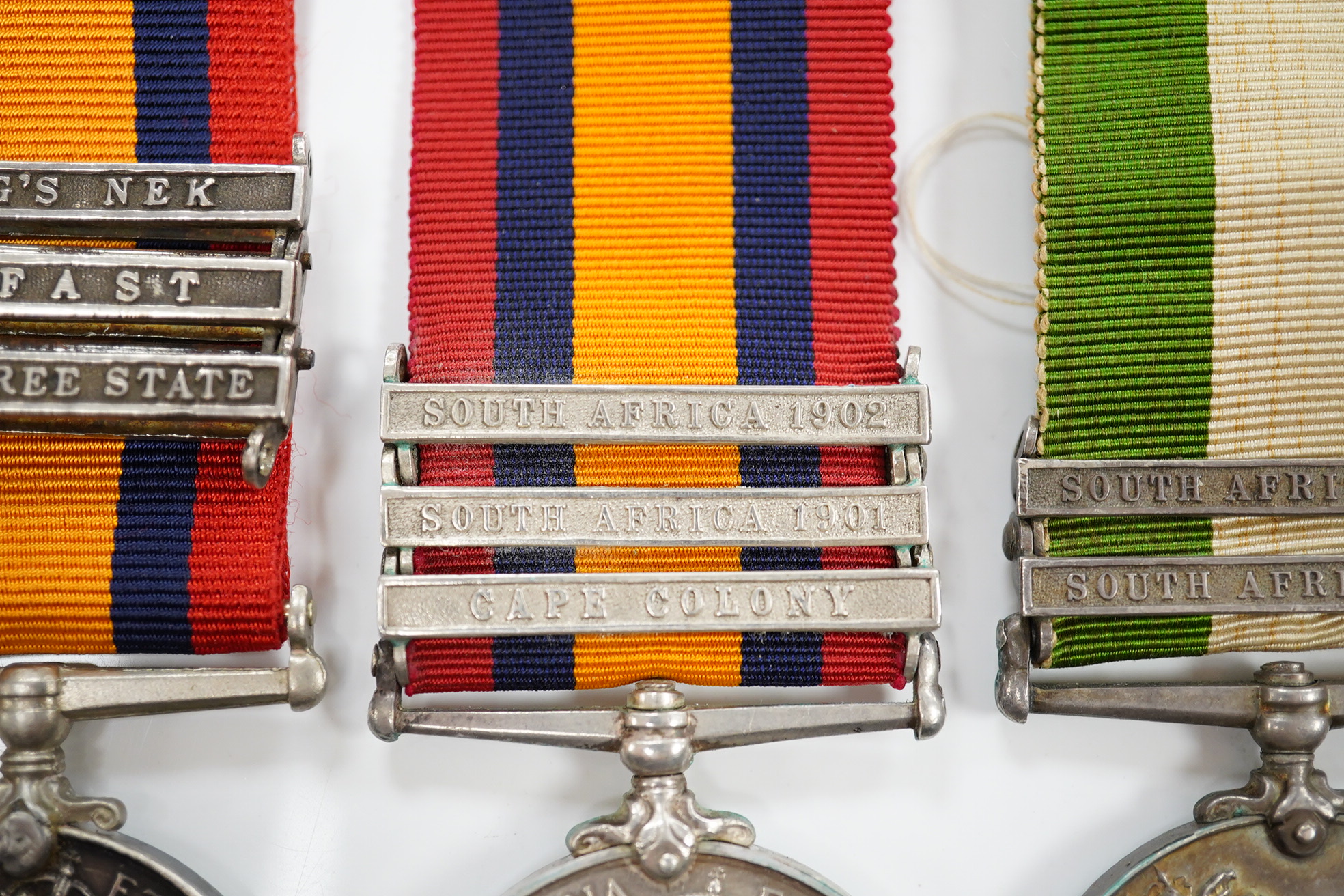 A Queen's South Africa Medal with Laings Nek, Belfast and OFS clasps to 12036 Bomr M.Miller R.F.A.Arty, another unnamed with 1901, 1902 and CC clasps, and two King's South Africa medals both with 1901/1902 clasps to 6408